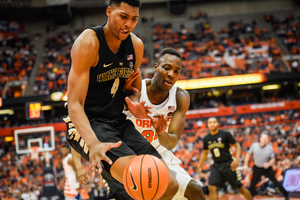 Doral Moore (left) exposed SU for 16 points and rebounds down low. To respond, SU collapsed its defense, but Wake Forest's hot shooters made the Orange pay.