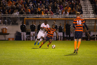 Mo Adams tries to retain possession with a Clemson player draped over him.