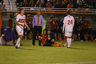 Pieles smiles as a trainer and head coach Ian McIntyre tend to him.