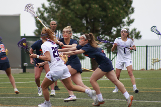 Claire Quinn gets double-teamed by Syracuse defenders.